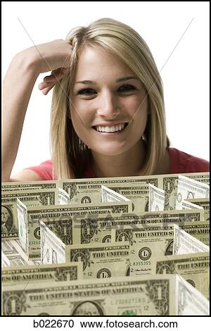 Stock Image - woman looking at a maze made of dollars. Fotosearch