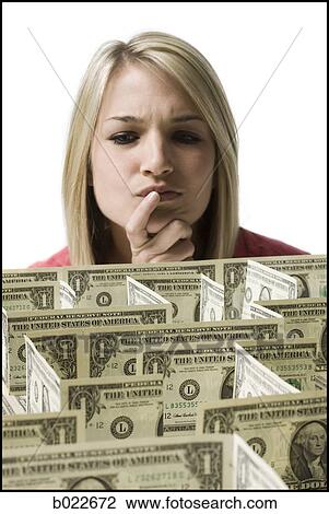 woman looking at a maze made of dollars View Large Photo Image Stock Image - woman looking at a maze made of dollars. Fotosearch