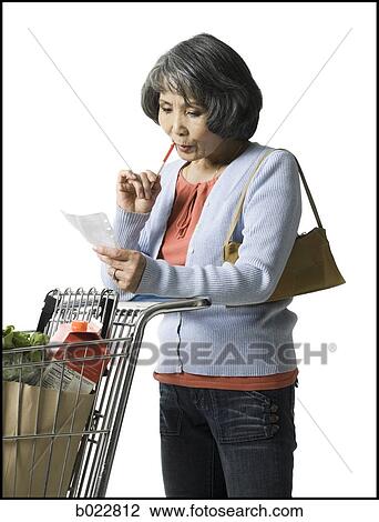 woman looking at a shopping list View Large Photo Image Stock Image - woman looking at a shopping list. Fotosearch