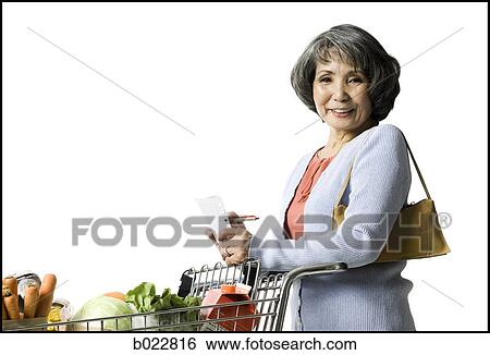 Stock Photograph - woman looking at a shopping list. Fotosearch