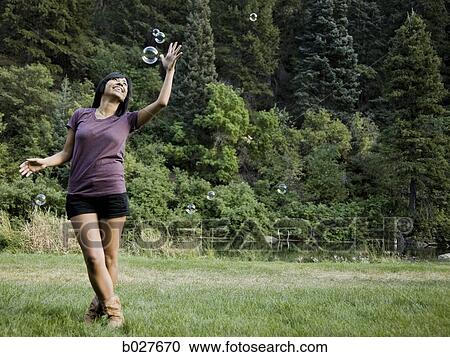 woman looking at bubbles View Large Photo Image Stock Image - woman looking at bubbles. Fotosearch