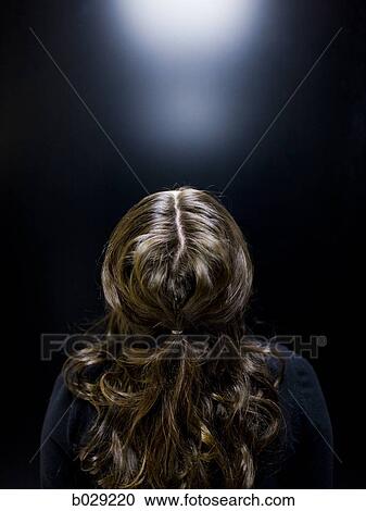 Stock Image - woman looking up. Fotosearch