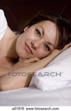 woman lying down looking at camera View Large Photo Image Stock Photograph - woman lying down looking at camera. Fotosearch