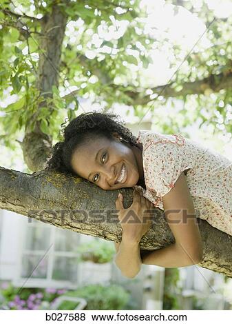 woman lying down on a tree branch View Large Photo Image Stock Photo - woman lying down on a tree branch. Fotosearch