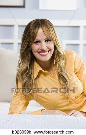 woman lying on a bed View Large Photo Image Stock Image - woman lying on a bed. Fotosearch