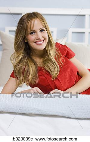 woman lying on a bed View Large Photo Image Stock Image - woman lying on a bed. Fotosearch
