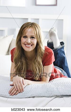 woman lying on a bed View Large Photo Image Stock Image - woman lying on a bed. Fotosearch