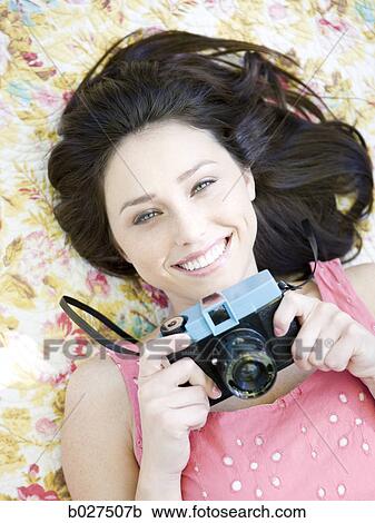 woman lying on a floral print blanket View Large Photo Image Stock Image - woman lying on a floral print blanket. Fotosearch