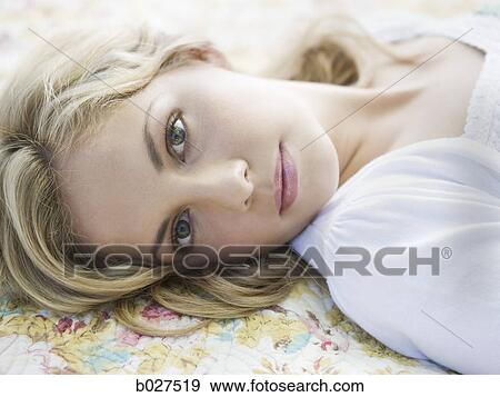 woman lying on a floral print blanket View Large Photo Image Stock Photo - woman lying on a floral print blanket. Fotosearch