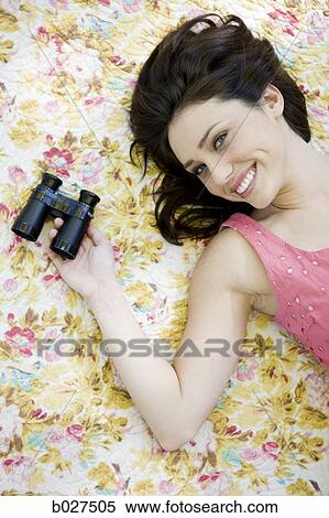 woman lying on a floral print blanket View Large Photo Image Stock Photography - woman lying on a floral print blanket. Fotosearch
