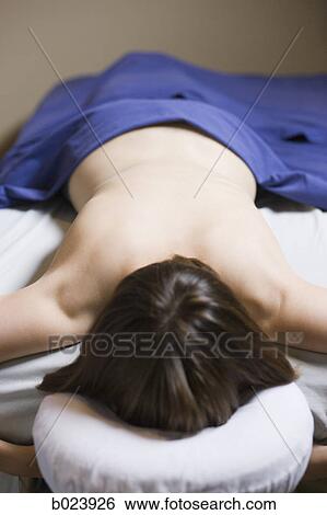 woman lying on a massage table View Large Photo Image Stock Photograph - woman lying on a massage table. Fotosearch