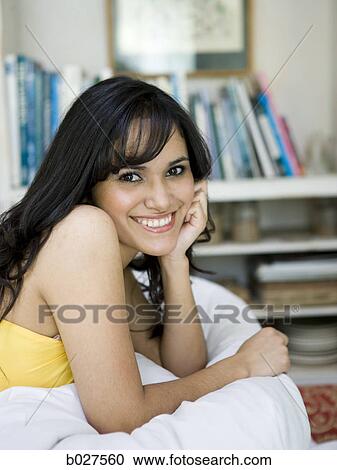 woman lying on the bed in her bedroom View Large Photo Image Stock Image - woman lying on the bed in her bedroom. Fotosearch