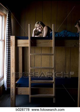 woman lying on the top bunk of a bunk bed View Large Photo Image Stock Photo - woman lying on the top bunk of a bunk bed. Fotosearch