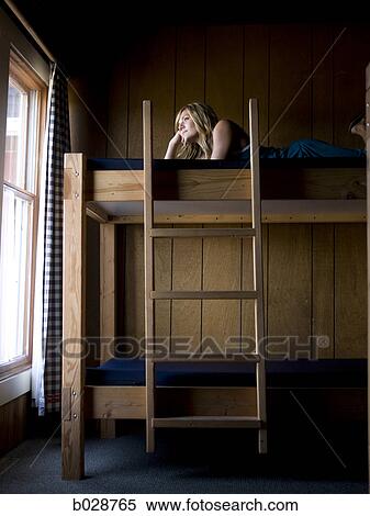woman lying on the top bunk of a bunk bed View Large Photo Image Stock Photography - woman lying on the top bunk of a bunk bed. Fotosearch