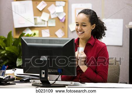 Stock Photo - woman making an online purchase. Fotosearch