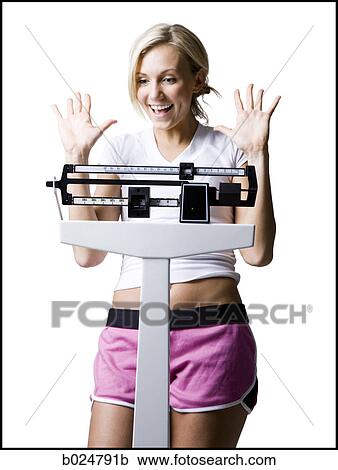 Stock Image - woman on a scale. Fotosearch