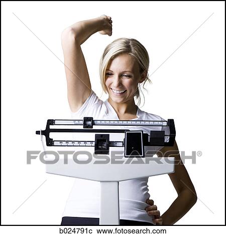 Stock Image - woman on a scale. Fotosearch