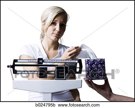 Stock Image - woman on a scale. Fotosearch