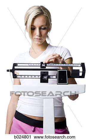 Stock Image - woman on a scale. Fotosearch