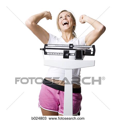 Stock Image - woman on a scale. Fotosearch