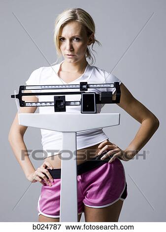Stock Photo - woman on a scale. Fotosearch