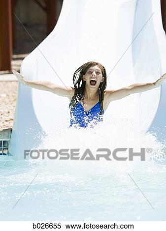 Stock Photography - woman on a water slide. Fotosearch