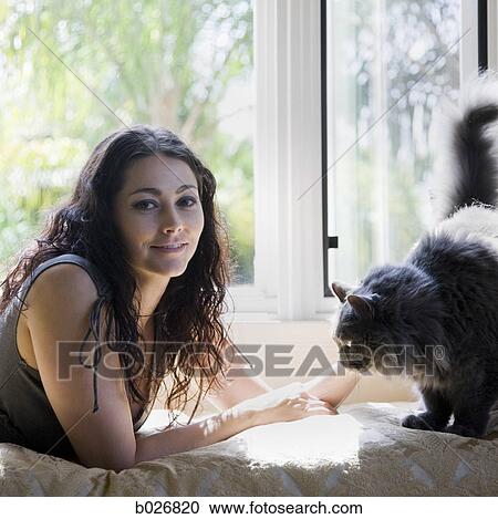 woman on a window bench with her cat View Large Photo Image Stock Image - woman on a window bench with her cat. Fotosearch