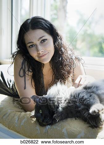 woman on a window bench with her cat View Large Photo Image Stock Image - woman on a window bench with her cat. Fotosearch
