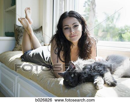 woman on a window bench with her cat View Large Photo Image Stock Photograph - woman on a window bench with her cat. Fotosearch