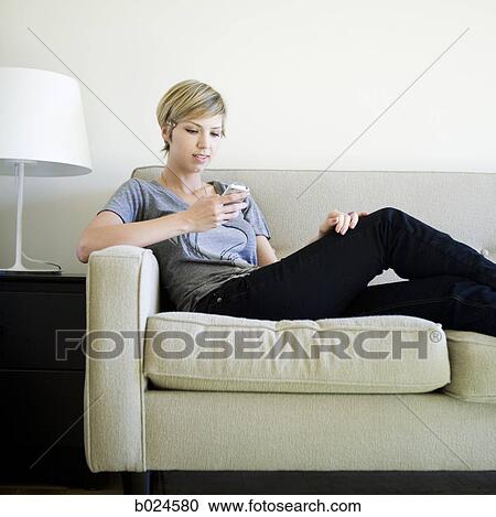 woman on the couch using cell phone View Large Photo Image Stock Image - woman on the couch using cell phone. Fotosearch