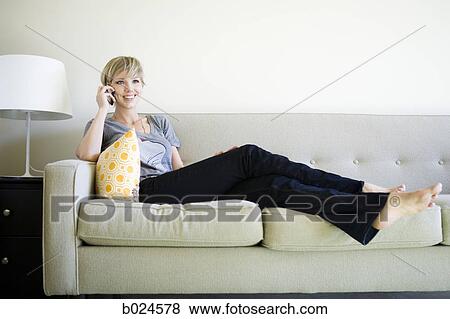 woman on the couch using cell phone View Large Photo Image Stock Photo - woman on the couch using cell phone. Fotosearch