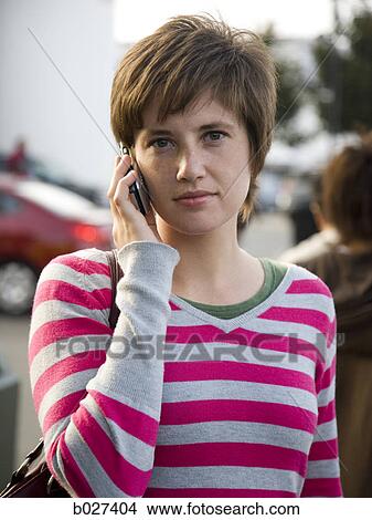 woman on the phone on a city street View Large Photo Image Picture - woman on the phone on a city street. Fotosearch