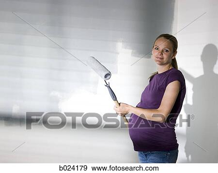 Stock Photo - woman painting a room. Fotosearch
