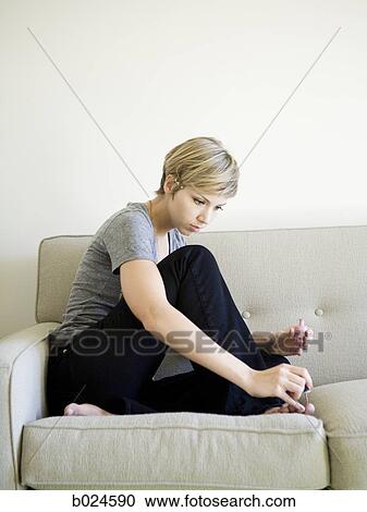 woman painting toenails on the couch View Large Photo Image Stock Image - woman painting toenails on the couch. Fotosearch