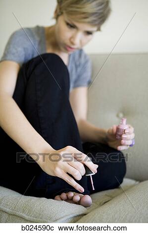 woman painting toenails on the couch View Large Photo Image Stock Image - woman painting toenails on the couch. Fotosearch