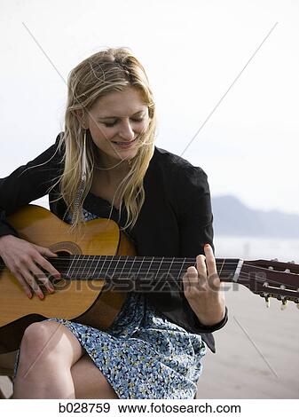 woman playing the guitar at the beach View Large Photo Image Stock Photo - woman playing the guitar at the beach. Fotosearch