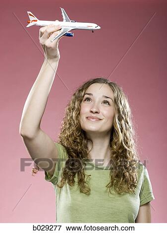 woman playing with a model airplane View Large Photo Image Stock Photo - woman playing with a model airplane. Fotosearch