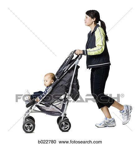 woman pushing her baby in a stroller View Large Photo Image Stock Image - woman pushing her baby in a stroller. Fotosearch
