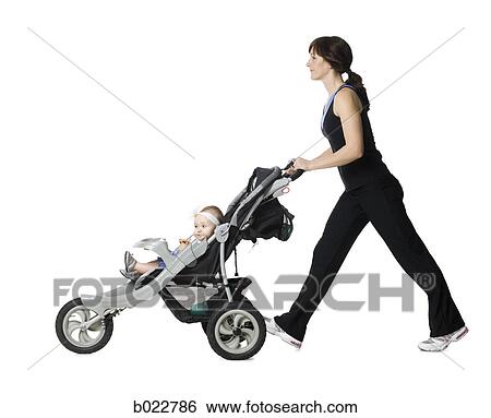 woman pushing her baby in a stroller View Large Photo Image Stock Photograph - woman pushing her baby in a stroller. Fotosearch