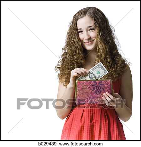 Stock Photo - woman putting money in her purse. Fotosearch