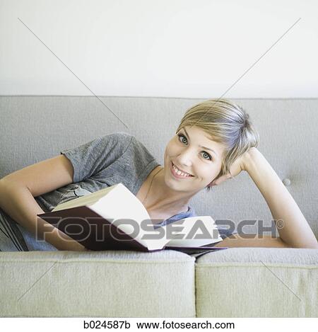 woman reading a book on the couch View Large Photo Image Stock Image - woman reading a book on the couch. Fotosearch