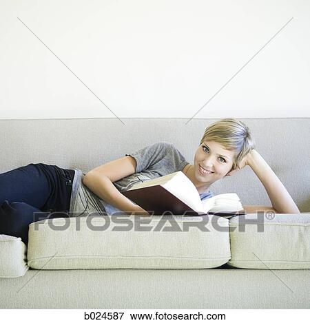 woman reading a book on the couch View Large Photo Image Stock Photo - woman reading a book on the couch. Fotosearch