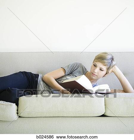 woman reading a book on the couch View Large Photo Image Stock Photograph - woman reading a book on the couch. Fotosearch