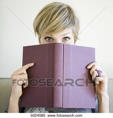 woman reading a book on the couch View Large Photo Image Stock Photography - woman reading a book on the couch. Fotosearch