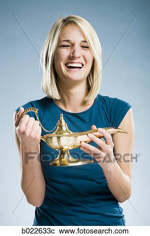 woman rubbing a magic lamp View Large Photo Image Stock Image - woman rubbing a magic lamp. Fotosearch
