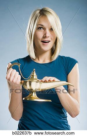 woman rubbing a magic lamp View Large Photo Image Stock Image - woman rubbing a magic lamp. Fotosearch