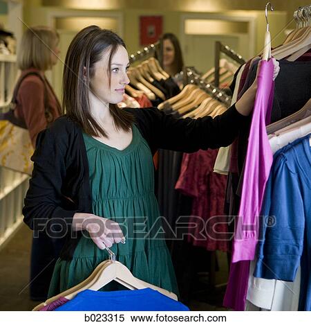 Stock Photography - woman shopping for clothes. Fotosearch