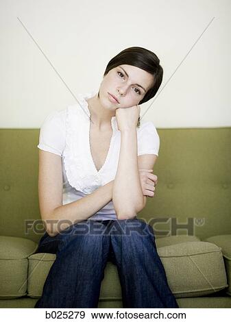 woman sitting on a sofa View Large Photo Image Stock Photo - woman sitting on a sofa. Fotosearch