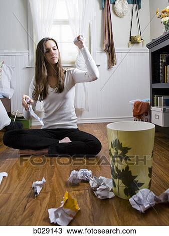 woman sitting on the floor throwing balls of paper into the wastebasket View Large Photo Image Stock Image - woman sitting on the floor throwing balls of paper into the wastebasket. Fotosearch