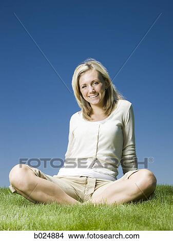 woman sitting on the grass View Large Photo Image Picture - woman sitting on the grass. Fotosearch